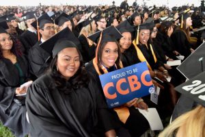 Graduating students with one holding Proud to Be CCBC sign